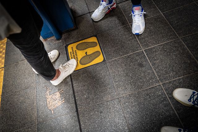 feet on a subway platform